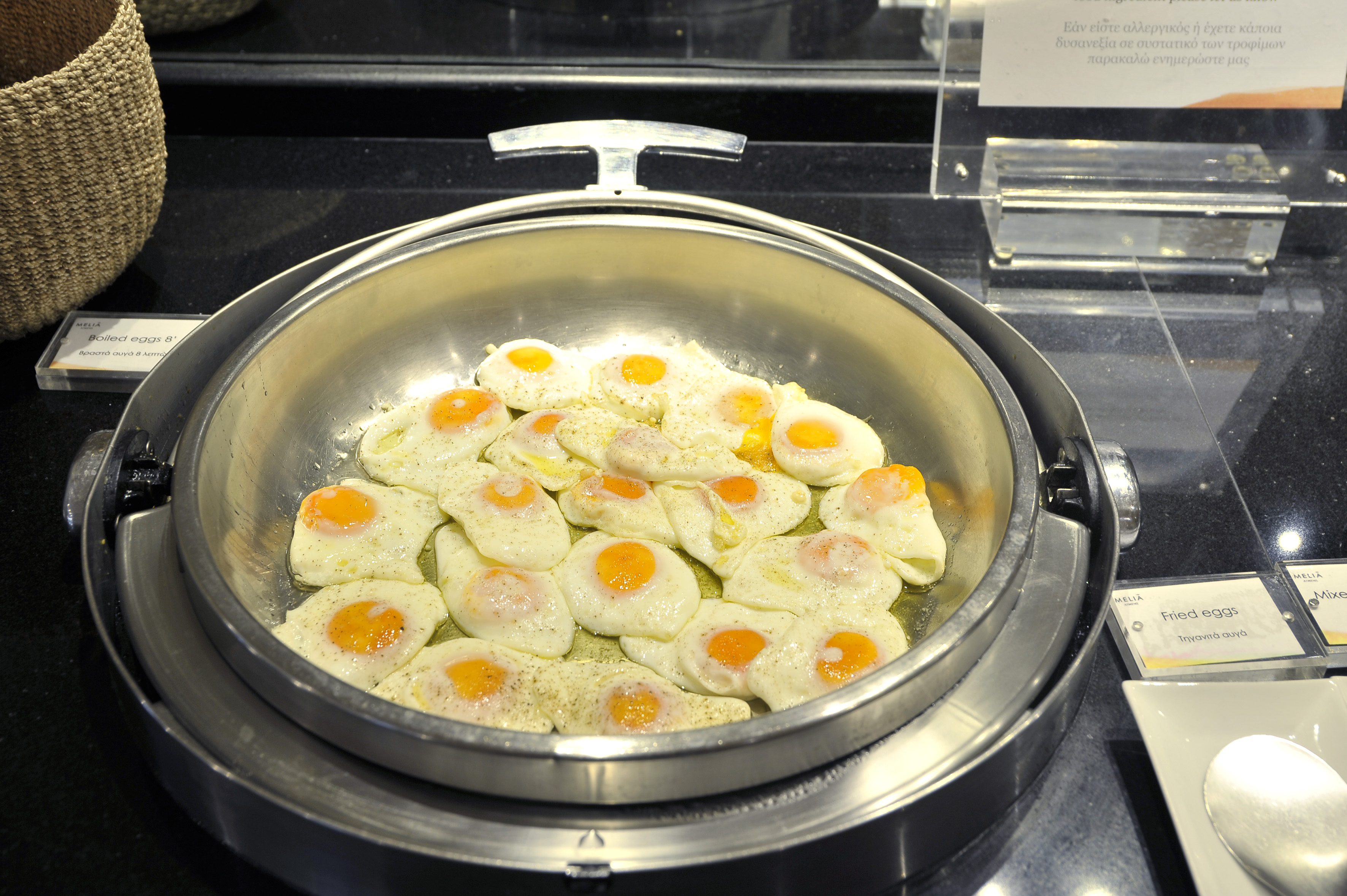 a pan of eggs cooking on a stove