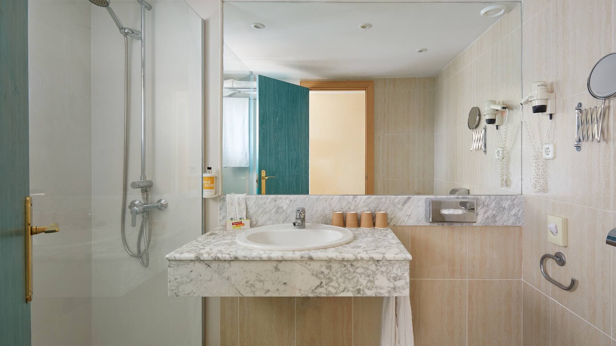 a bathroom with a marble countertop and shower