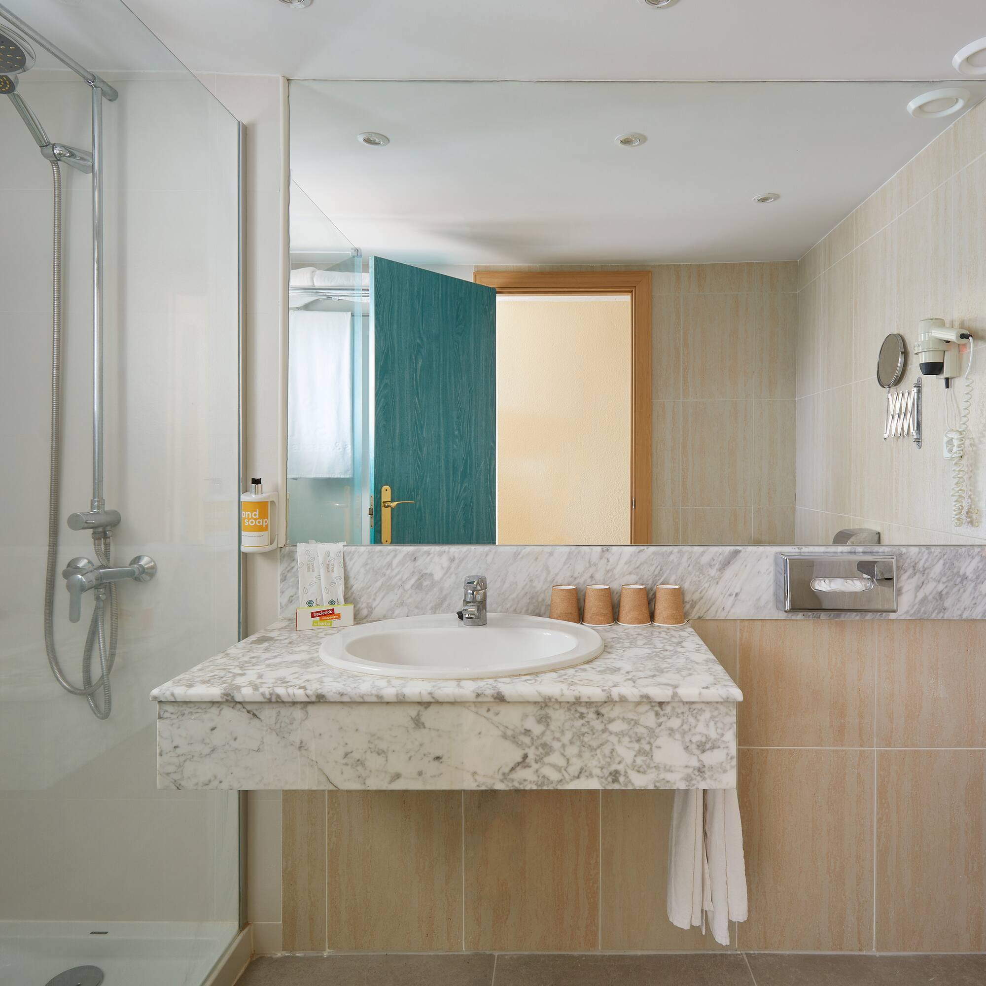 a bathroom with a marble countertop and shower