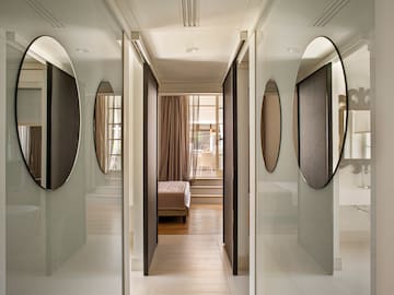 a hallway with mirrors and a bed