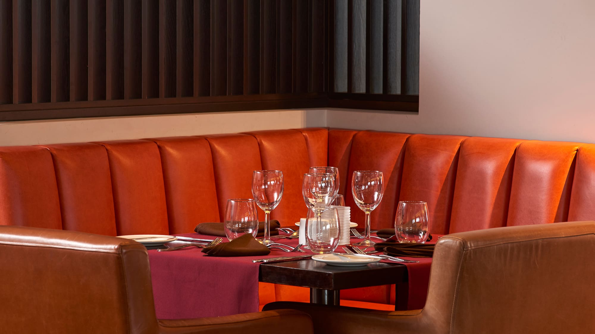 a table with wine glasses and plates on it