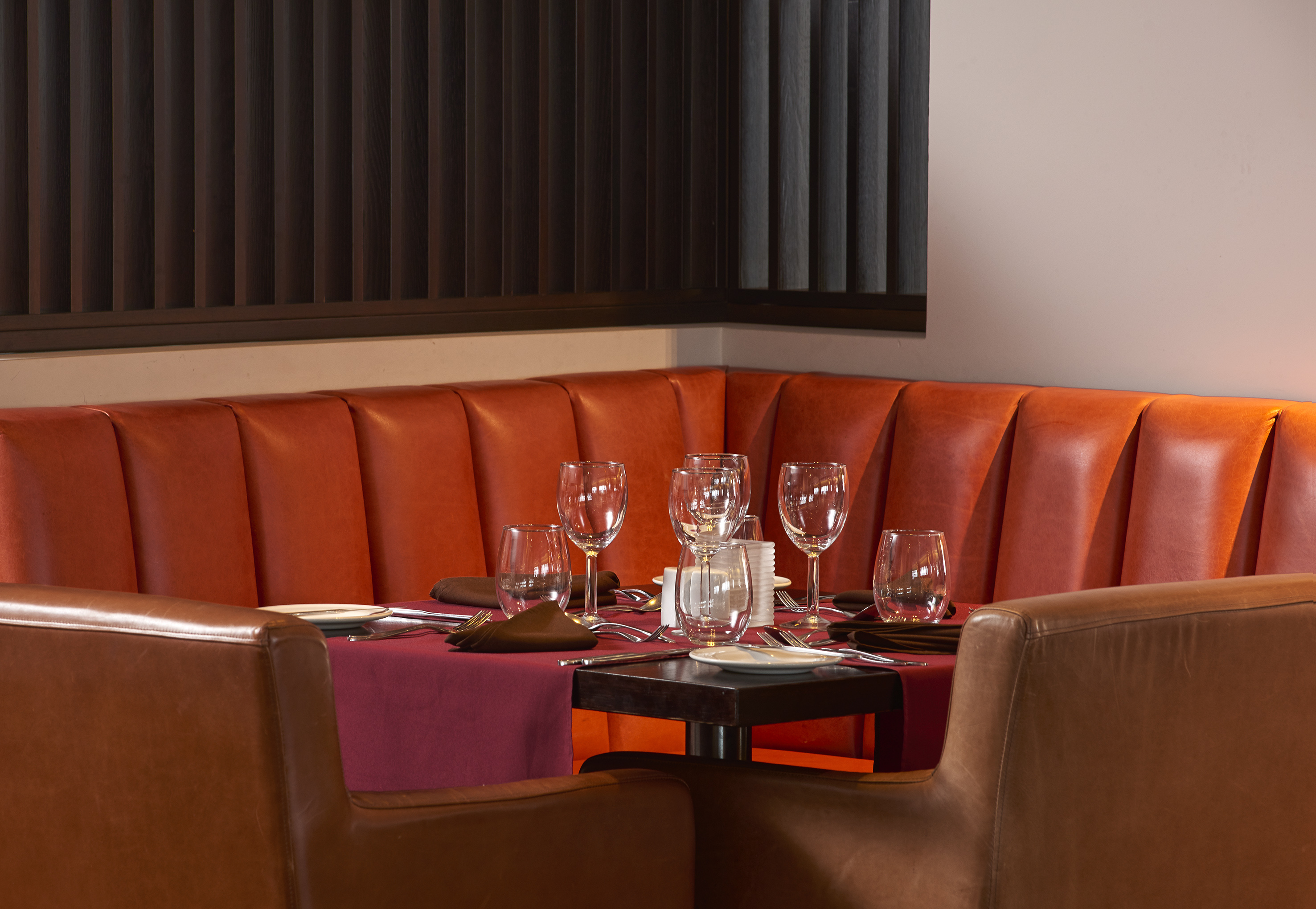 a table with wine glasses and plates on it