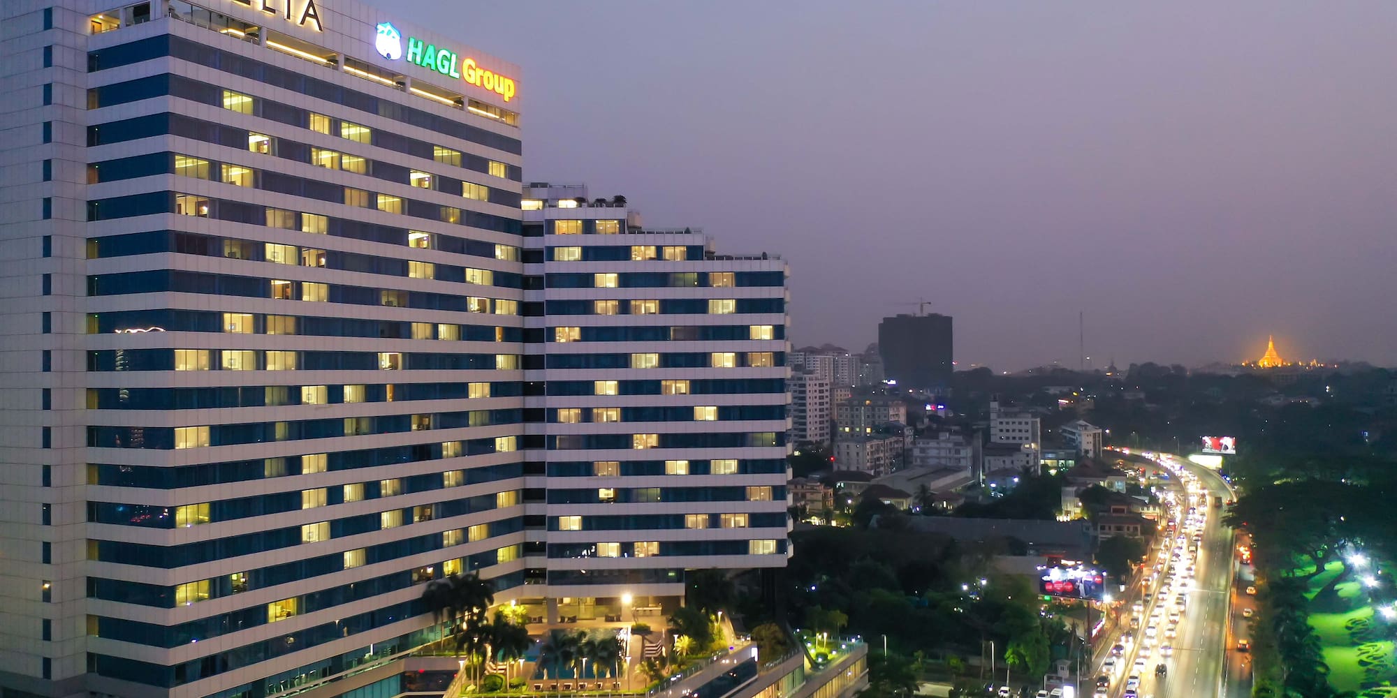 a tall building with many windows and a city street at night