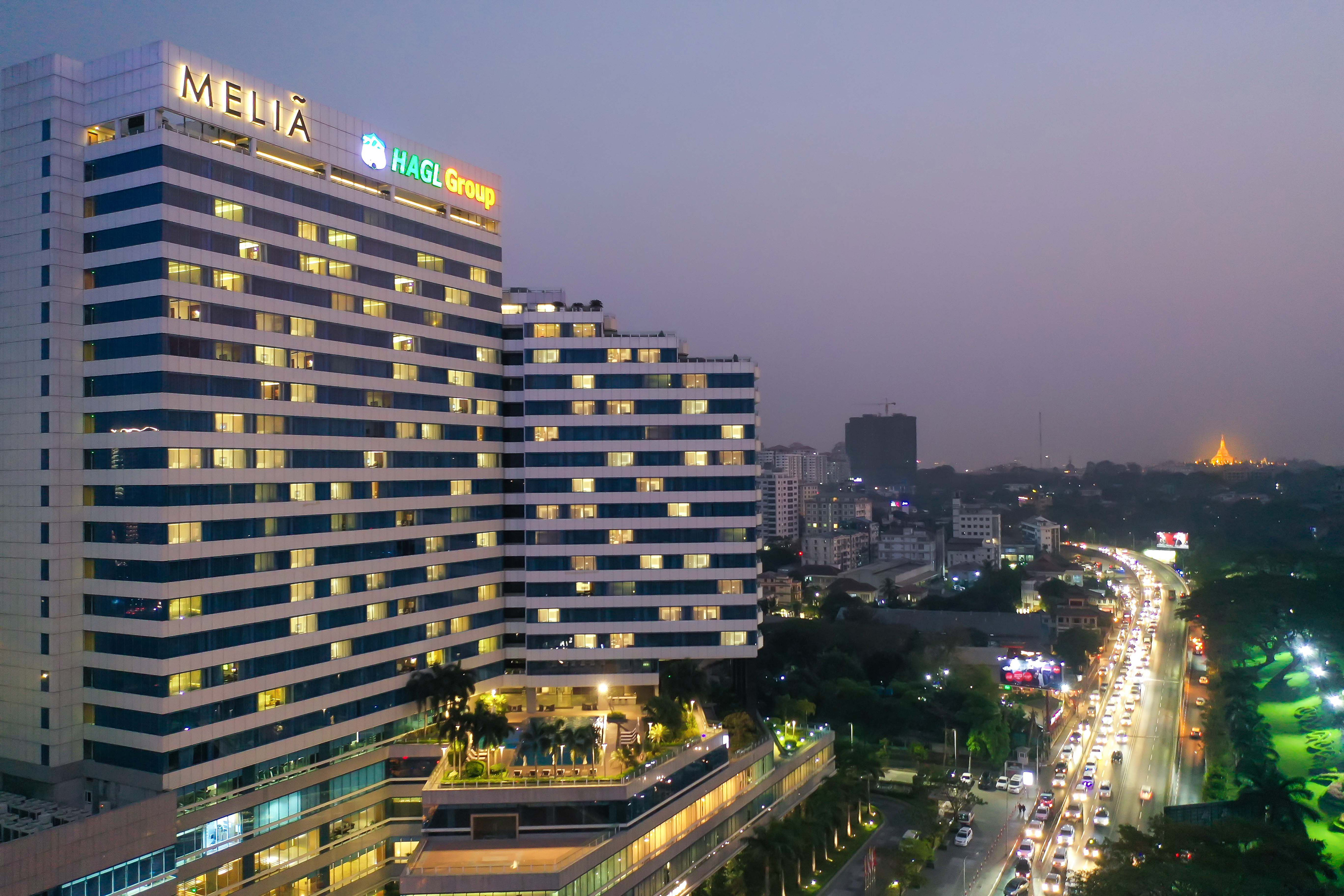 a tall building with many windows and a city street at night