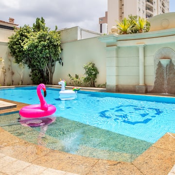 a pool with inflatable flamingo and unicorn in it