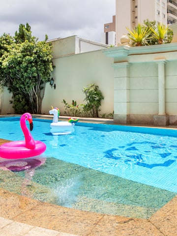 a pool with inflatable flamingo and unicorn in it