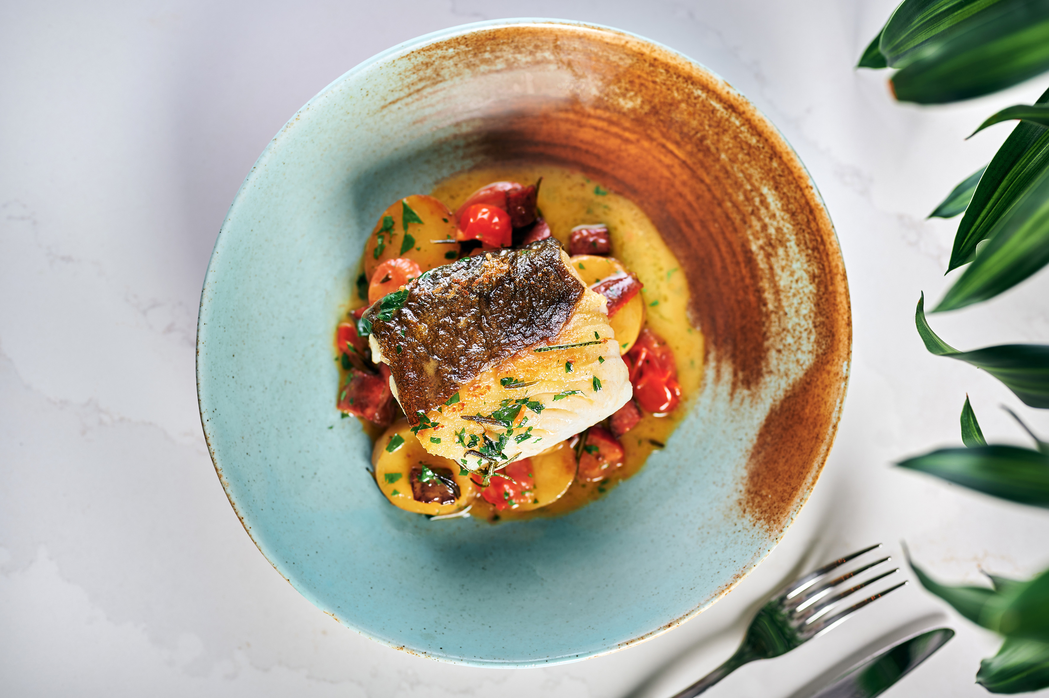 Crispy skin fish fillet with roasted potatoes, cherry tomatoes & herbs.