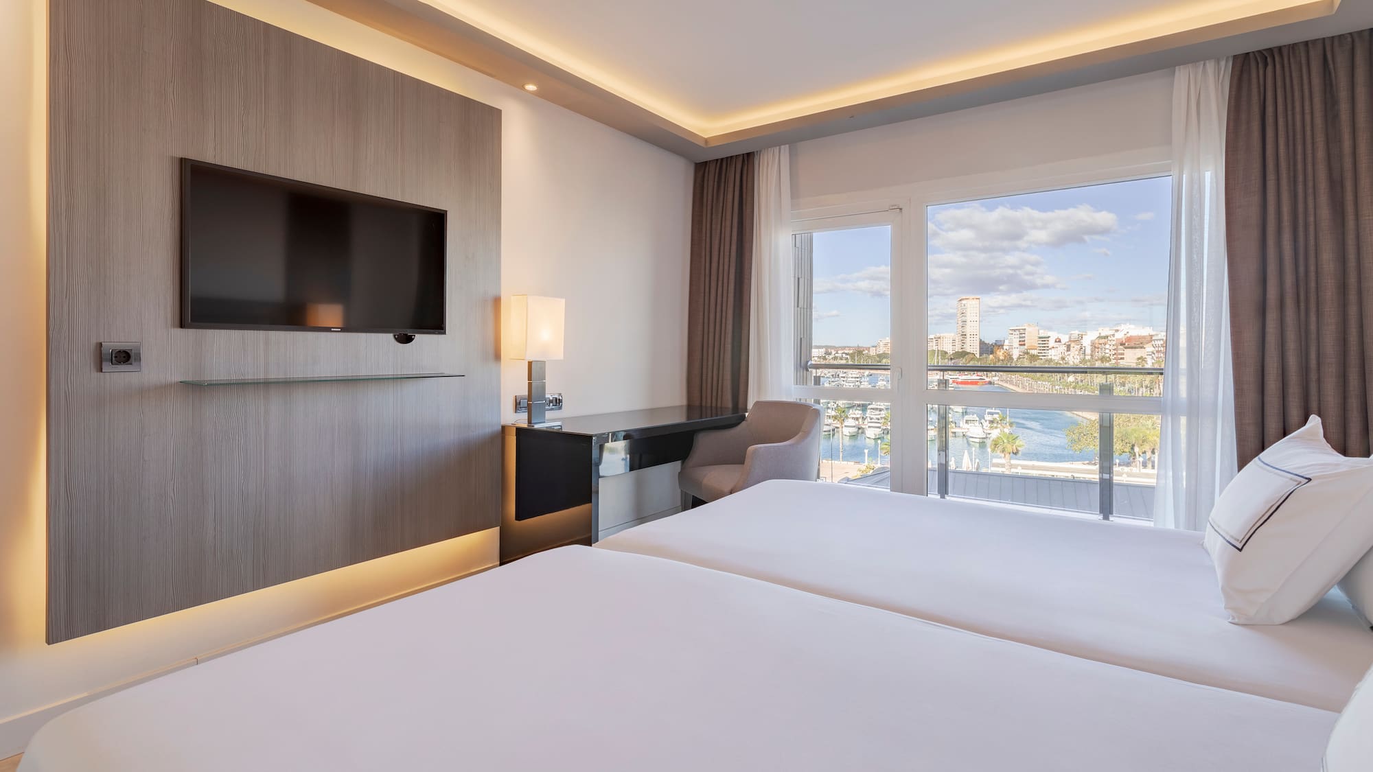 a room with a television and a view of the water