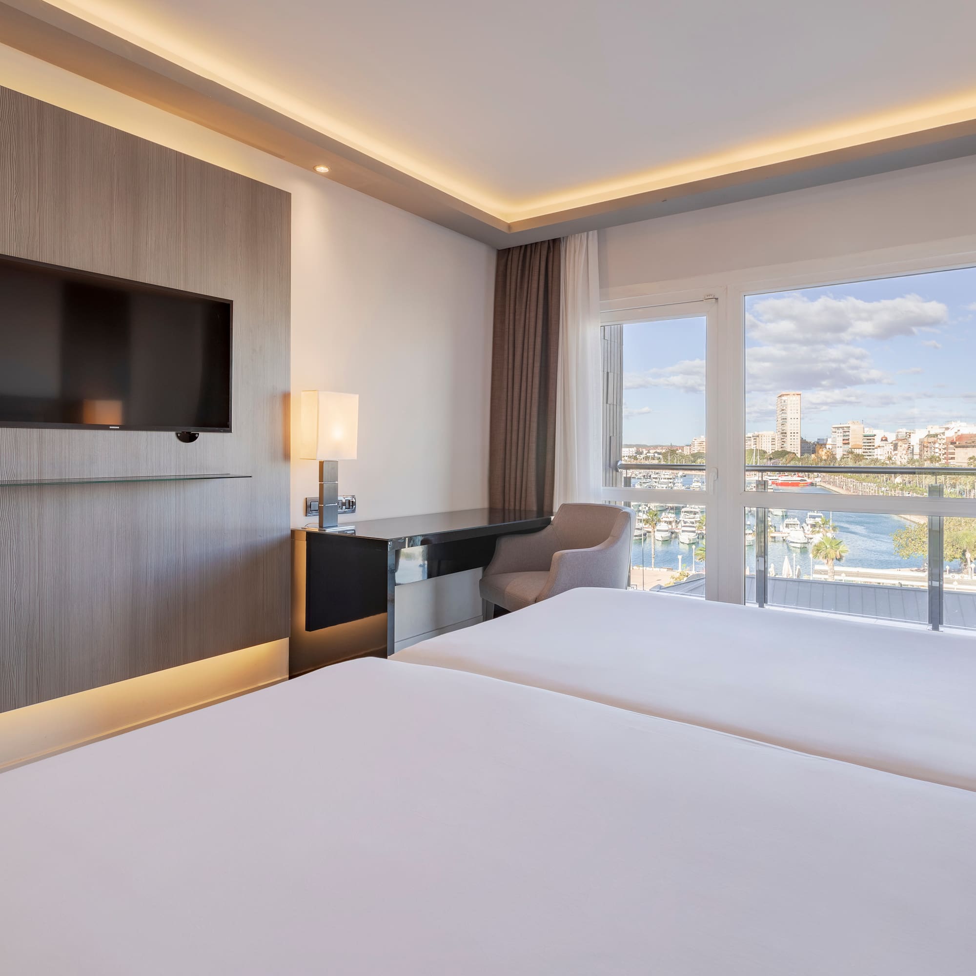 a room with a television and a view of the water