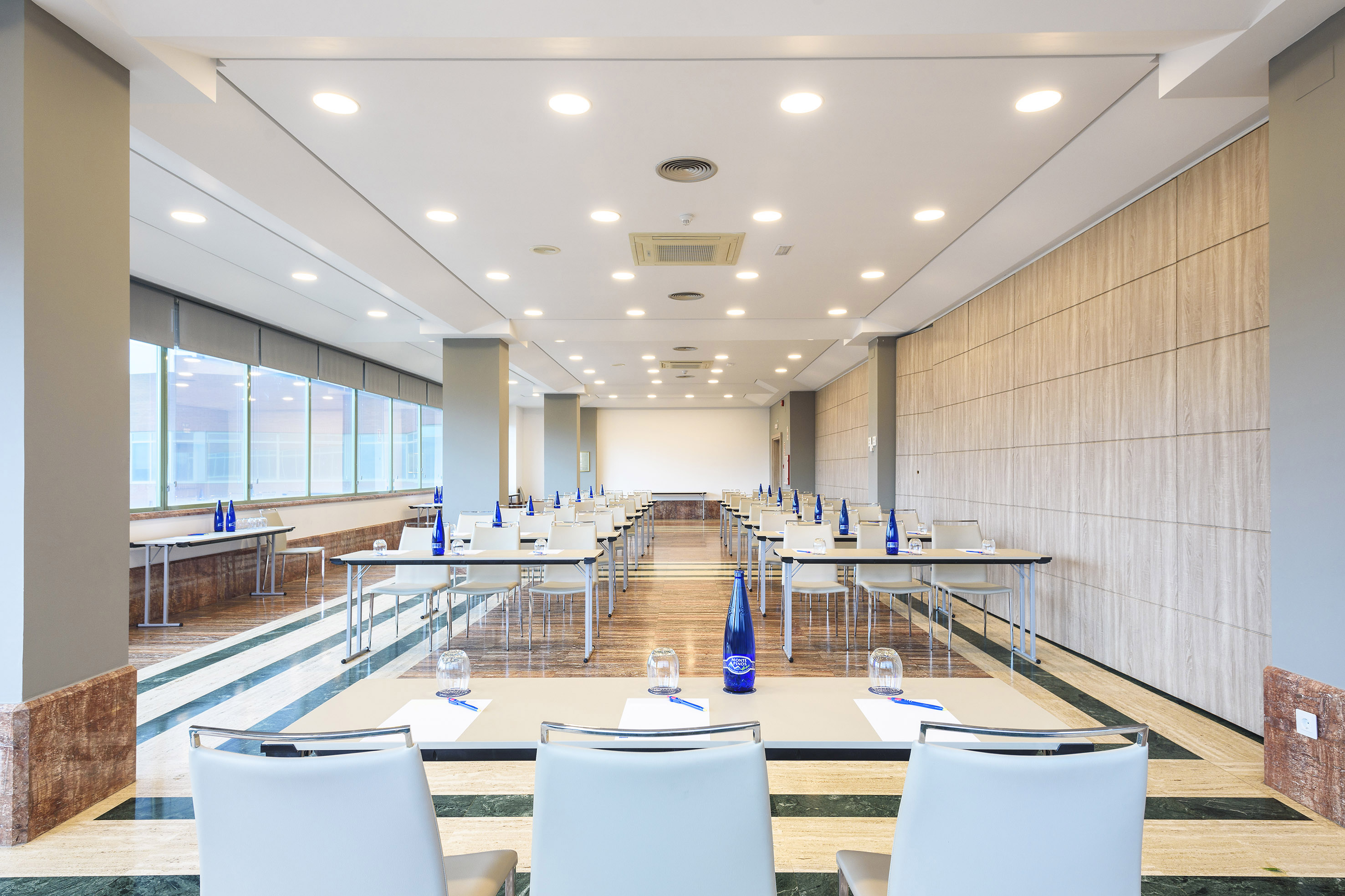 Bright, modern conference room with classroom setup for corporate meetings.