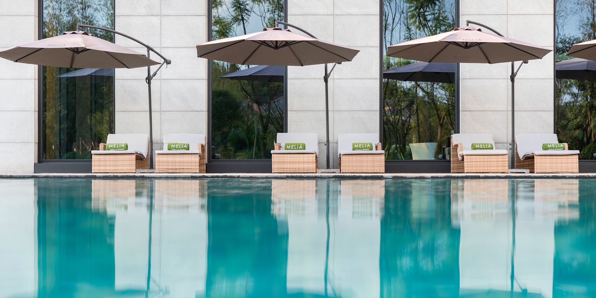 a pool with chairs and umbrellas