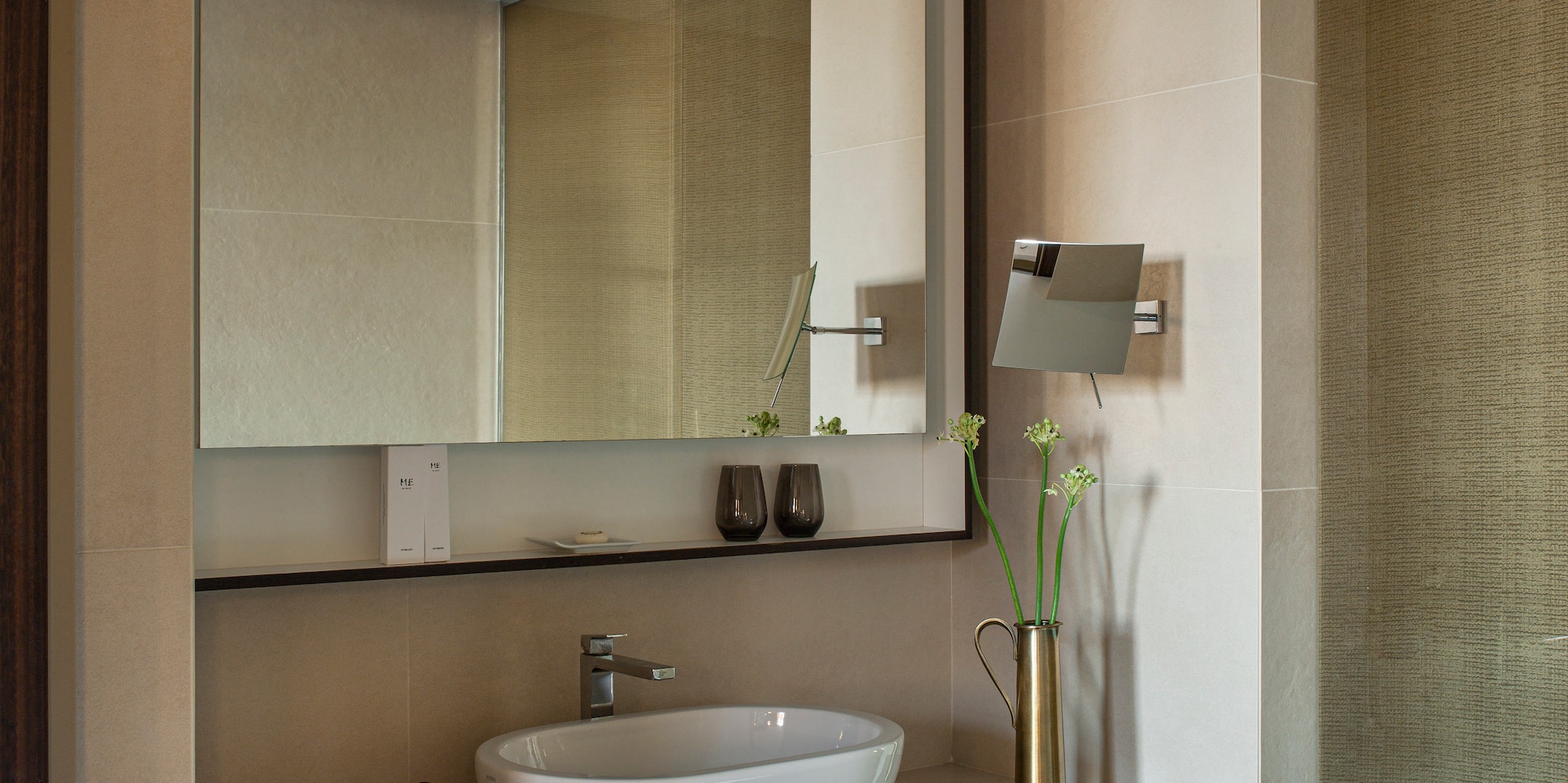 a bathroom with a mirror and sink