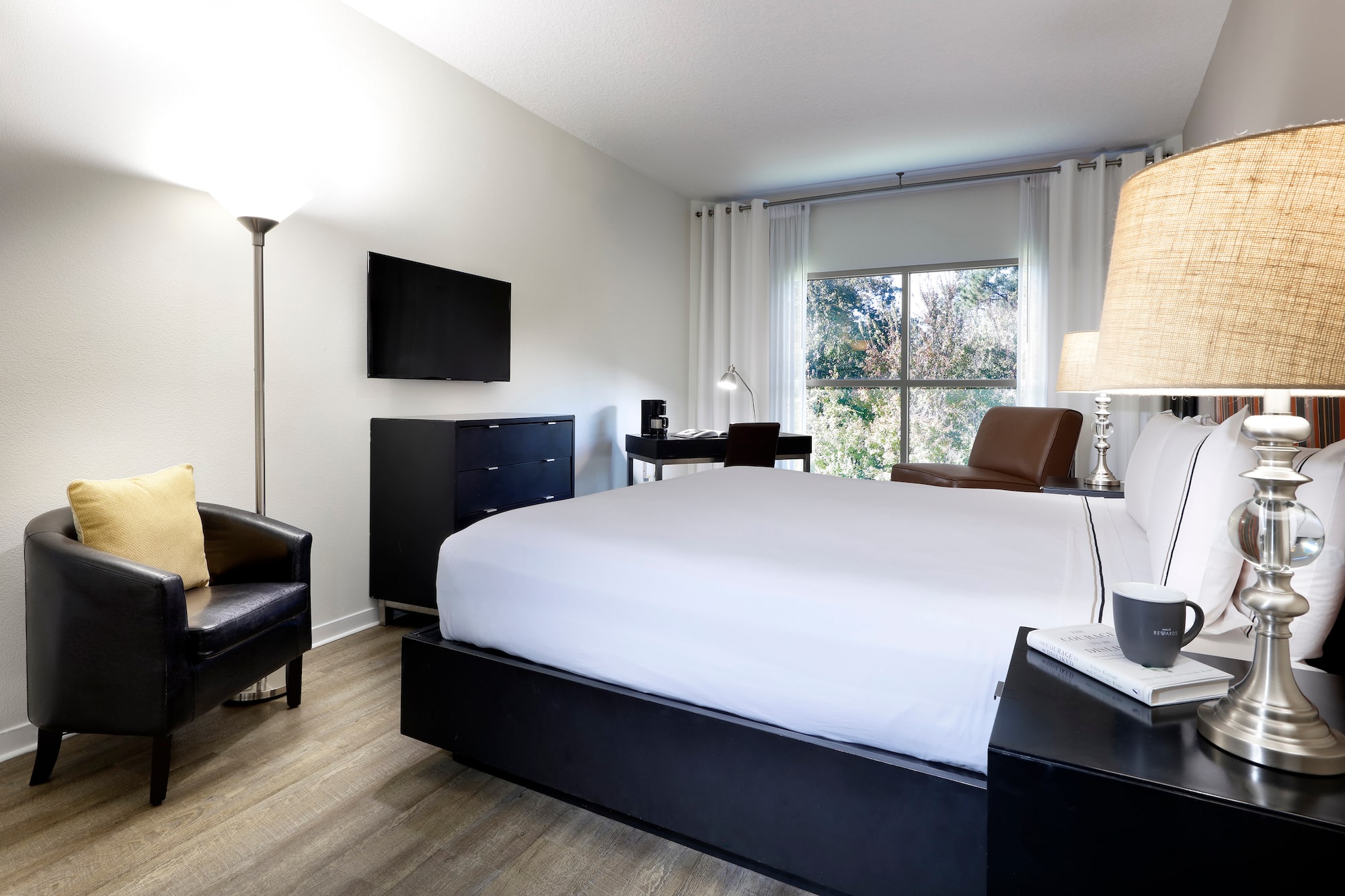 a bedroom with a bed and a tv