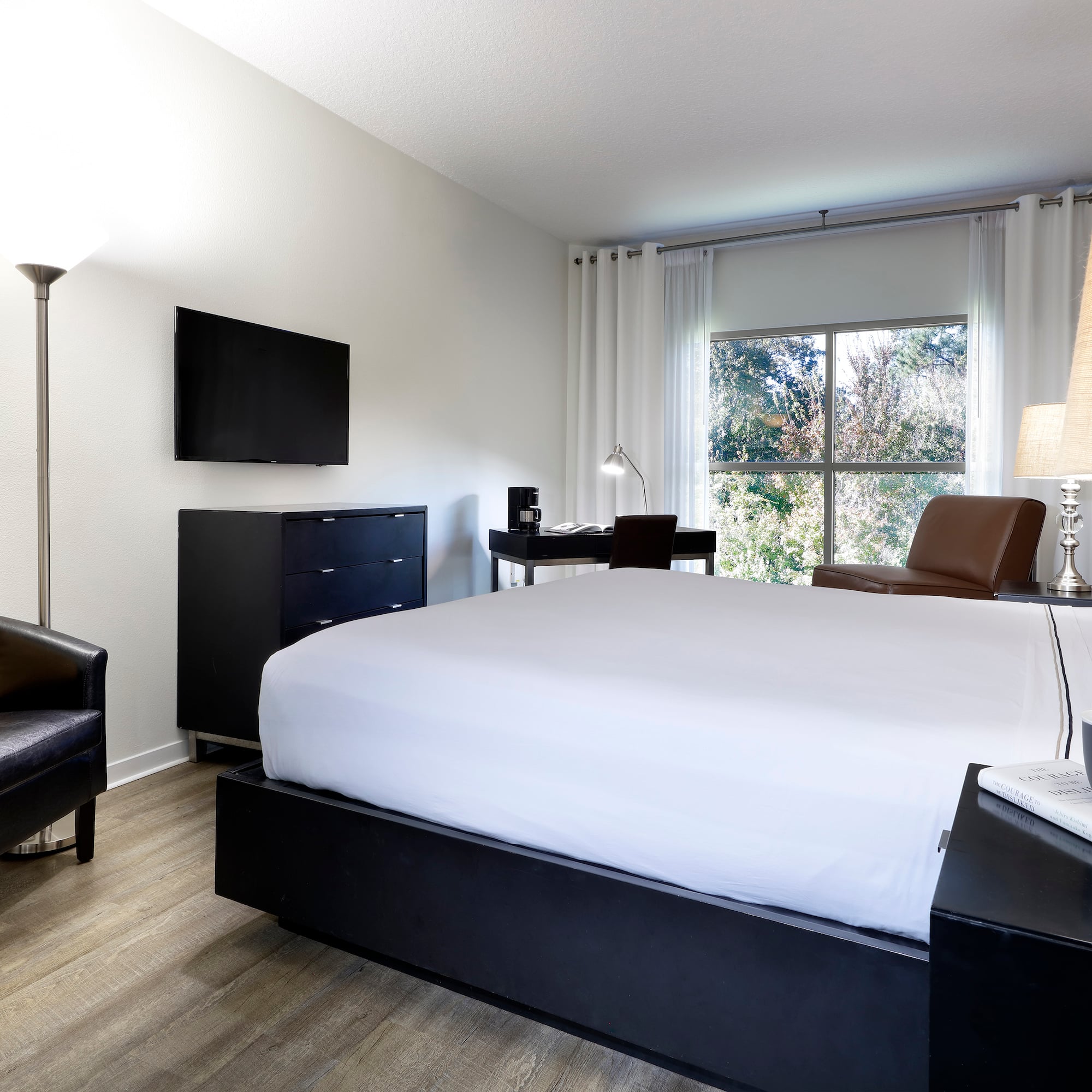 a bedroom with a bed and a tv