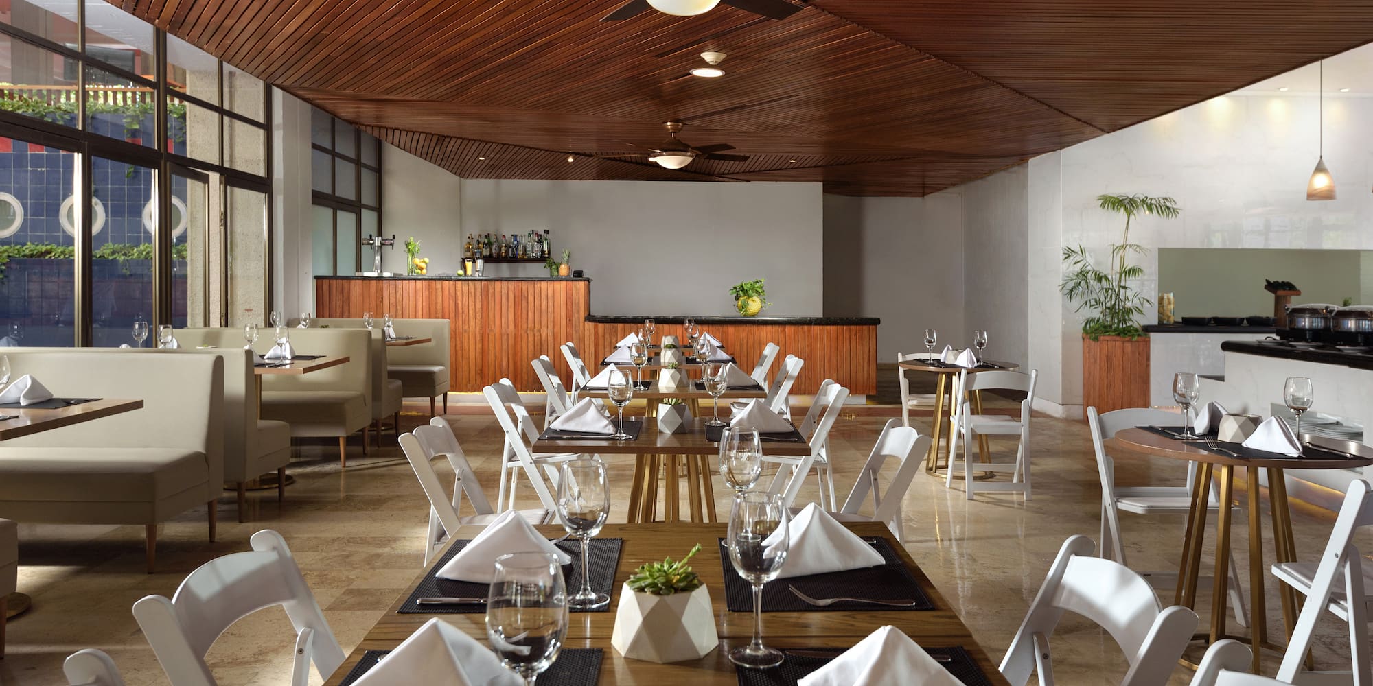 a room with tables and chairs and a bar