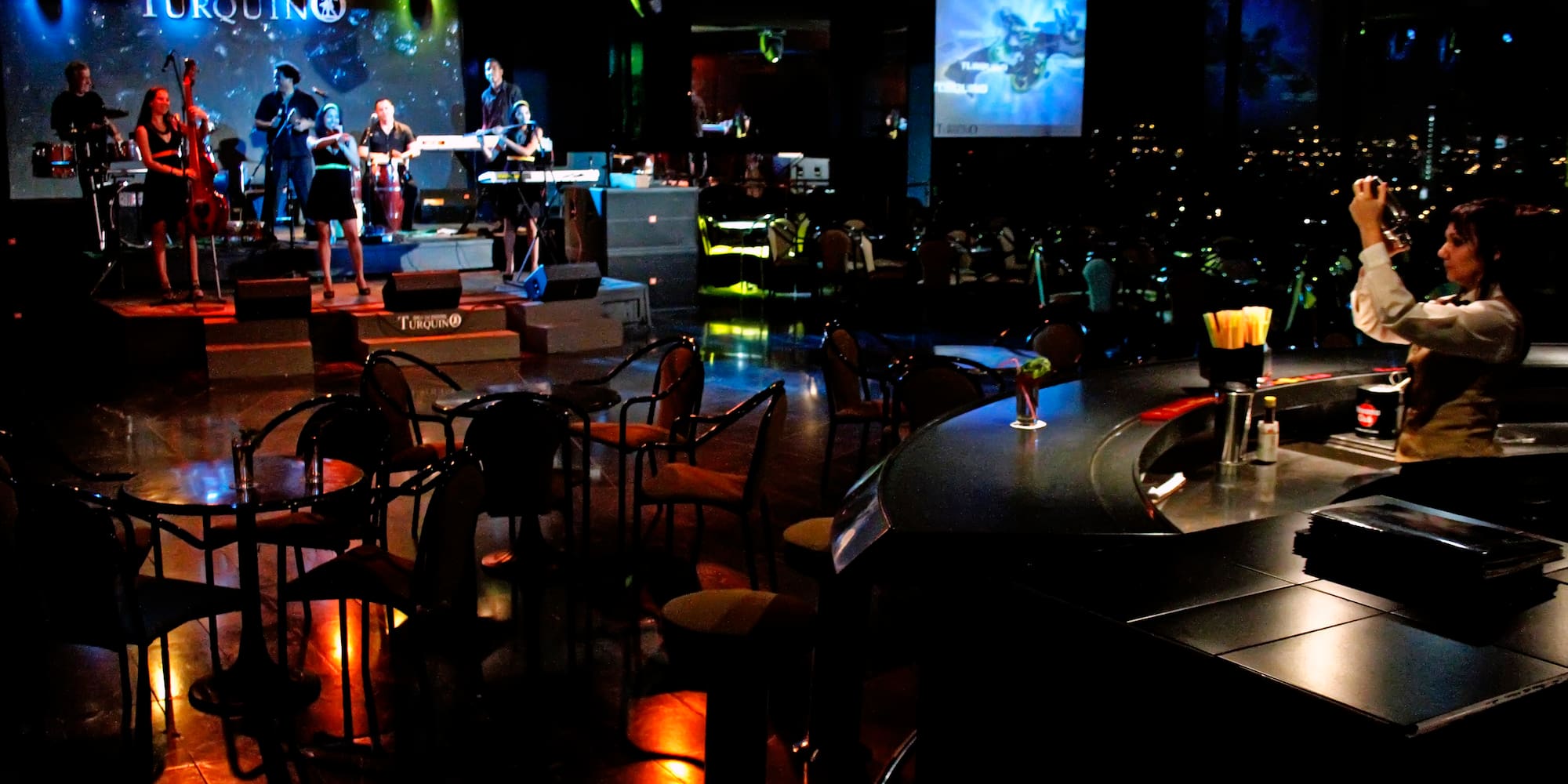 a group of people playing instruments in a dark room