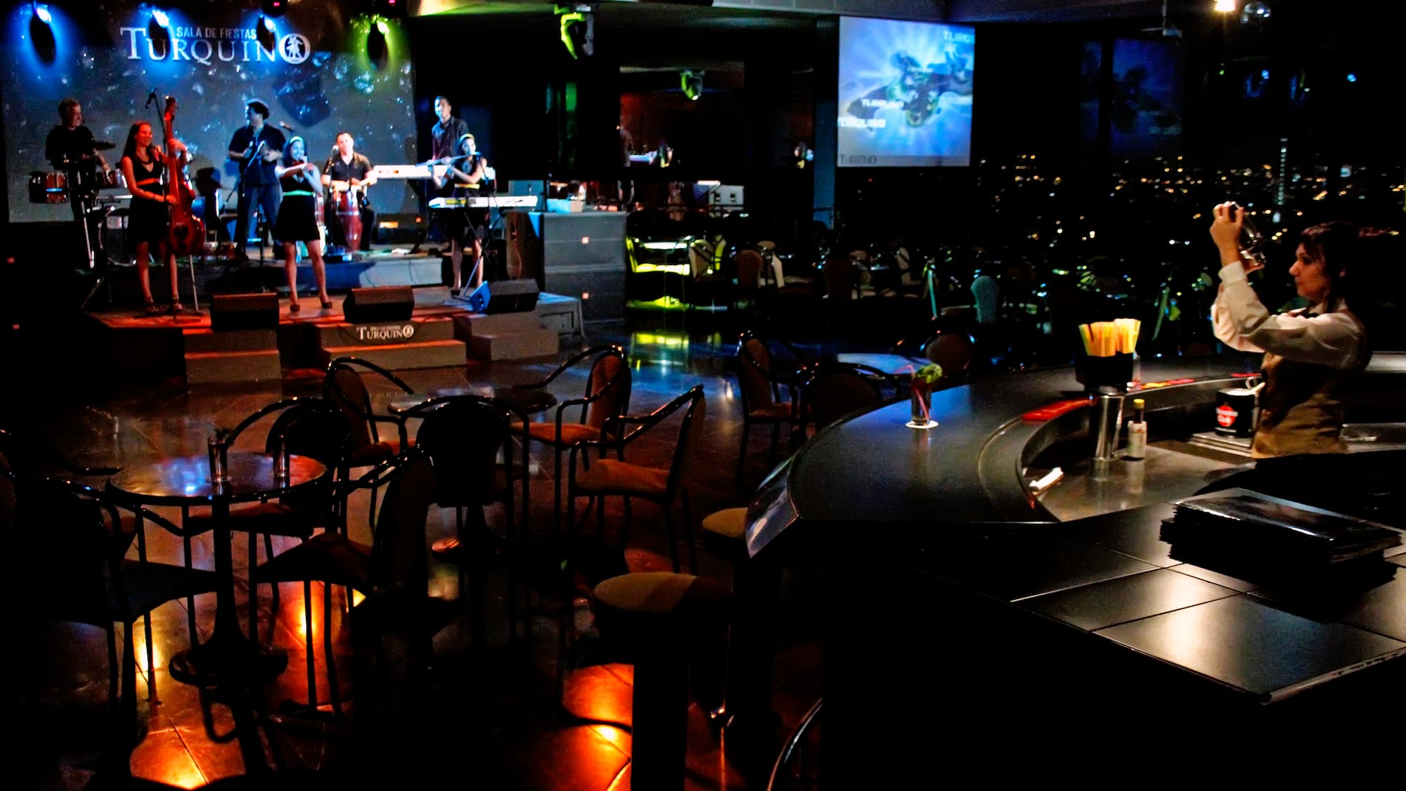 a group of people playing instruments in a dark room