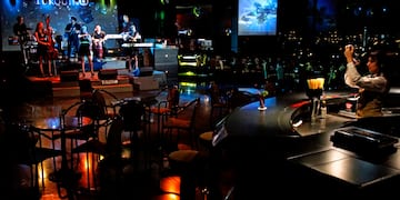 a group of people playing instruments in a dark room