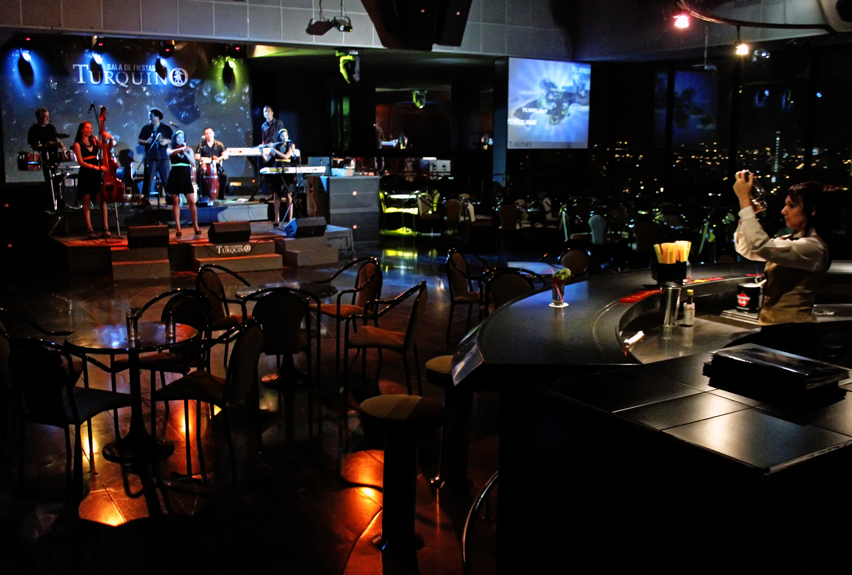 a group of people playing instruments in a dark room