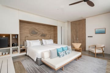 a bedroom with a bed and a fan