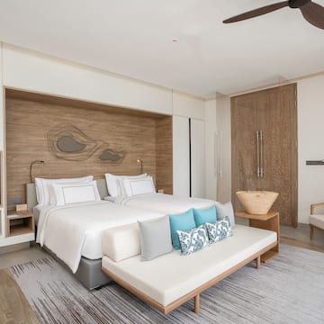a bedroom with a bed and a fan