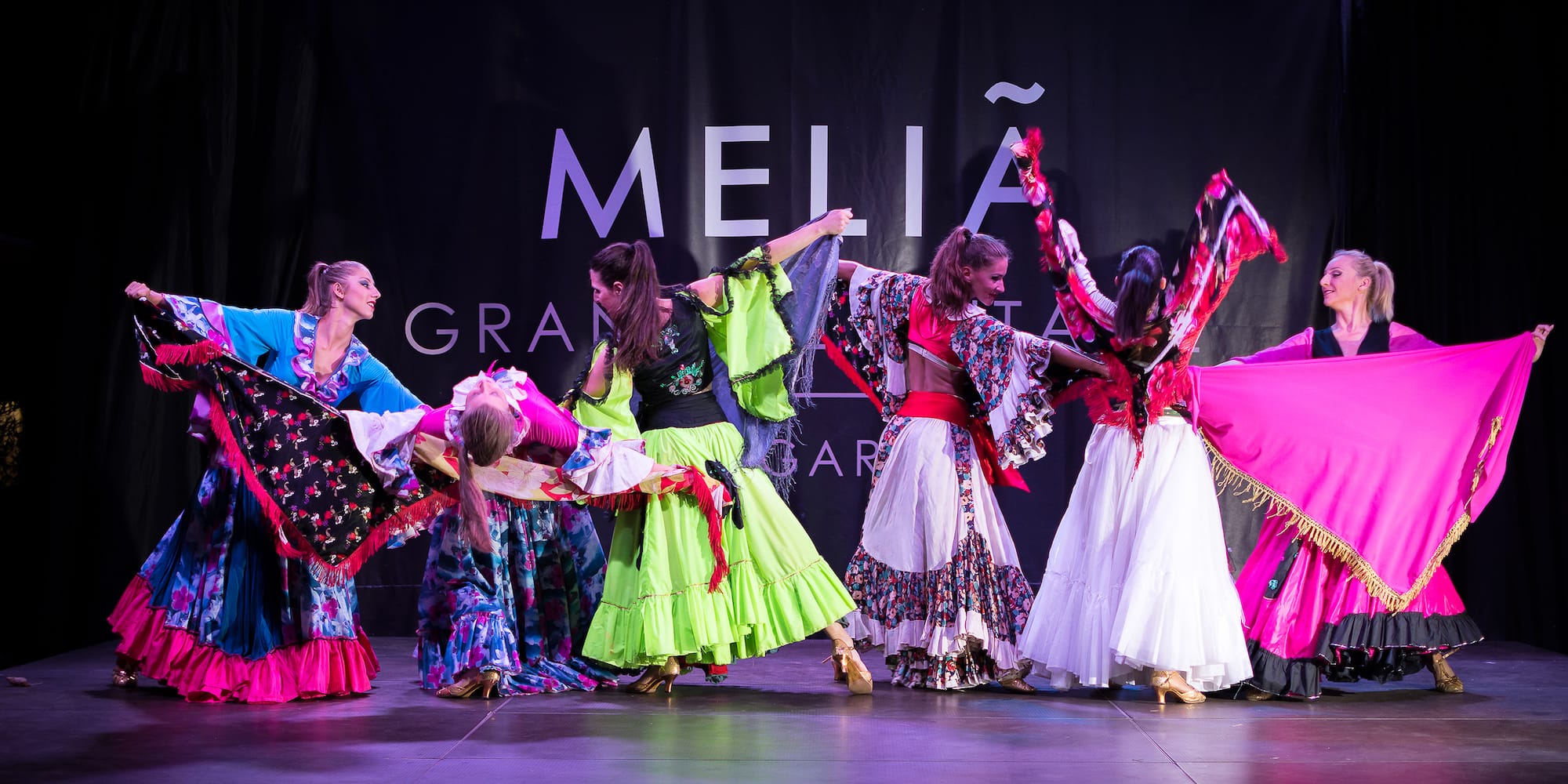 a group of women dancing on a stage