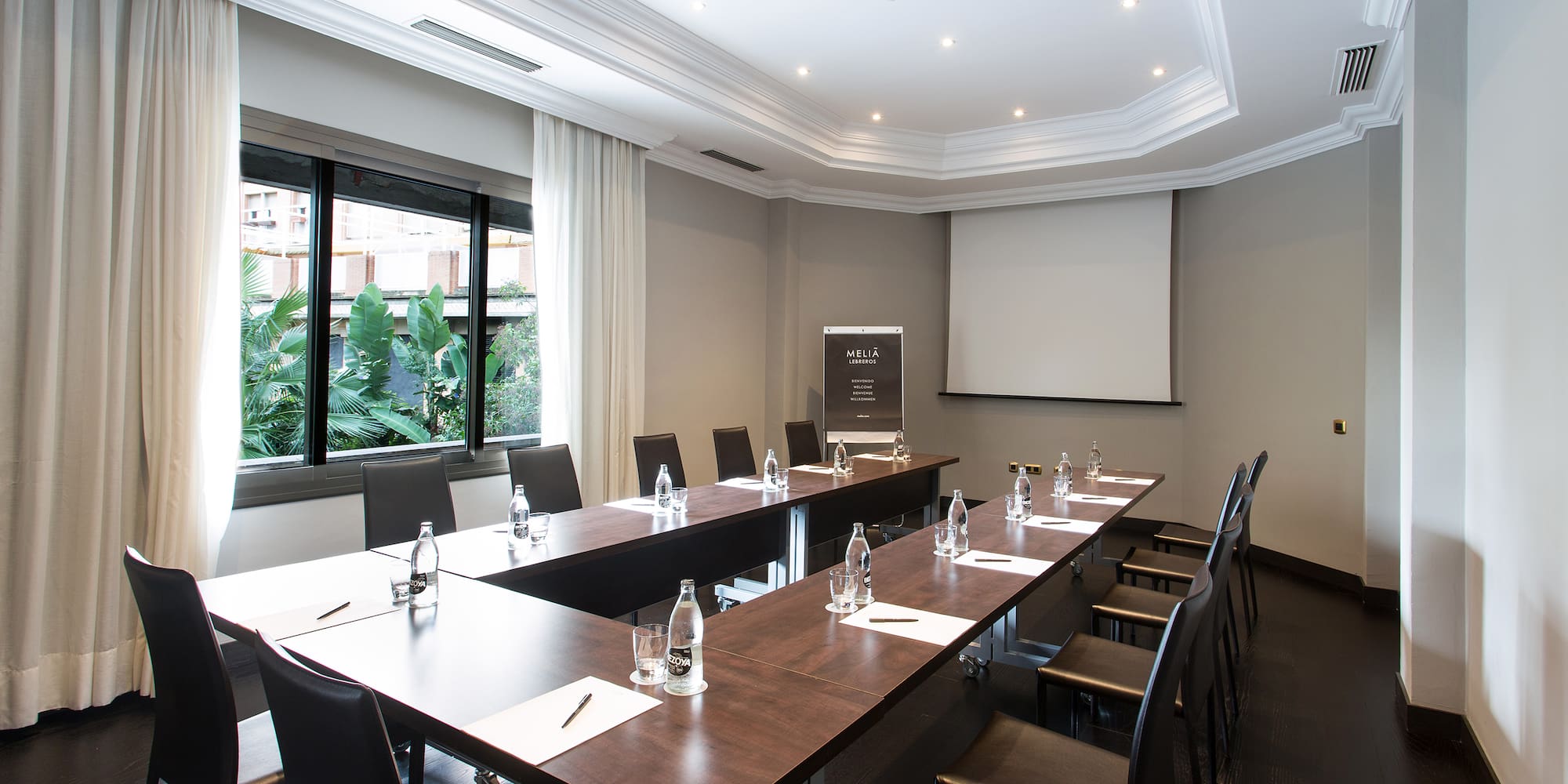 a room with long tables and chairs