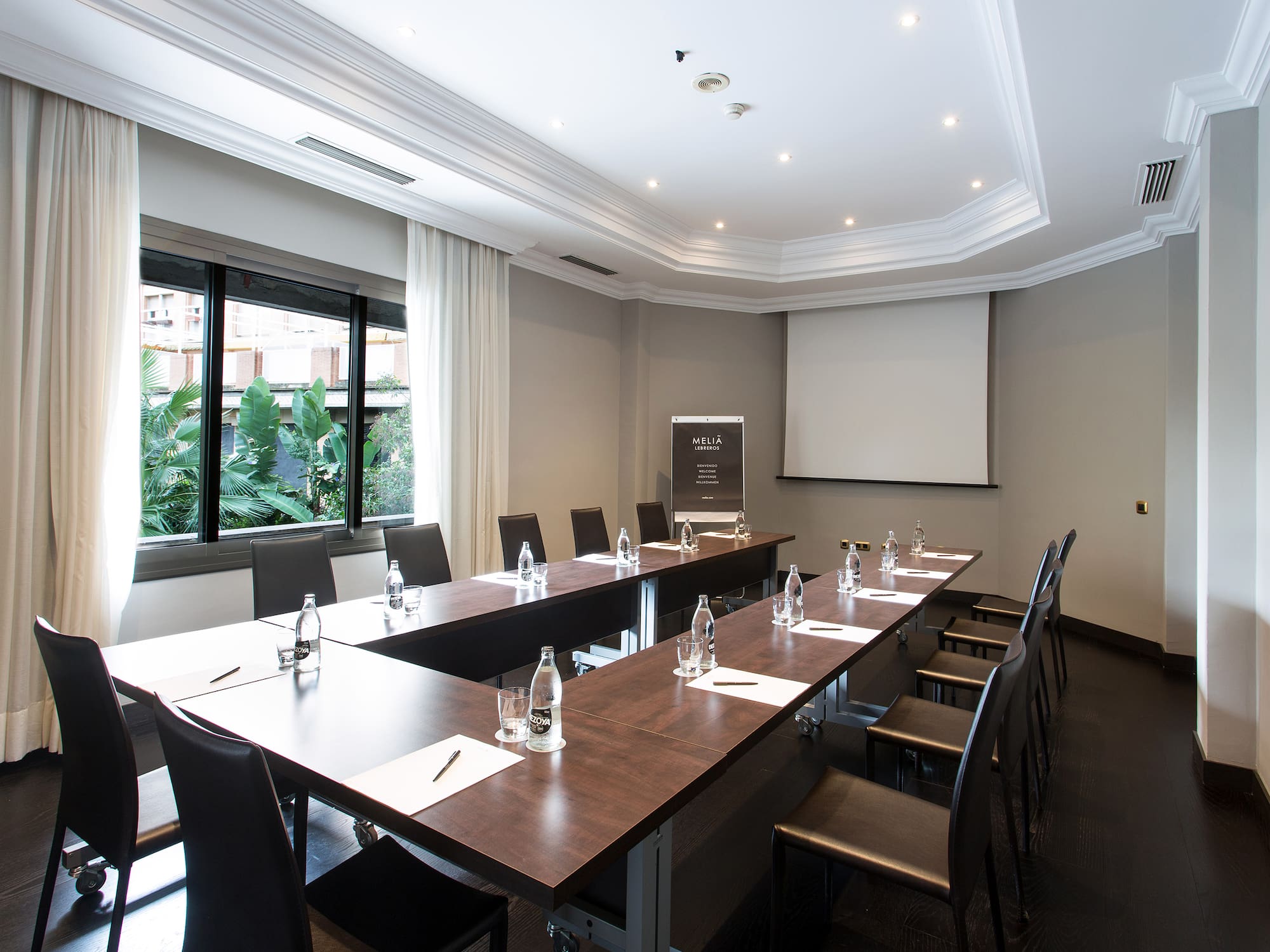 a room with long tables and chairs