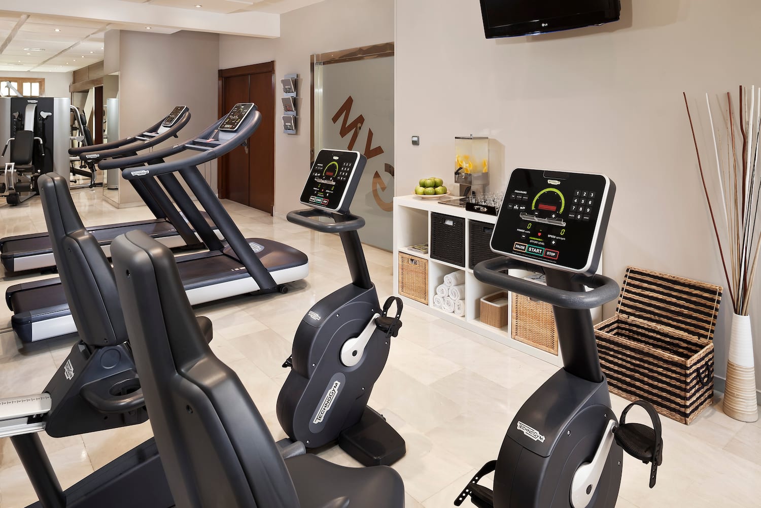 a room with exercise bikes and treadmills