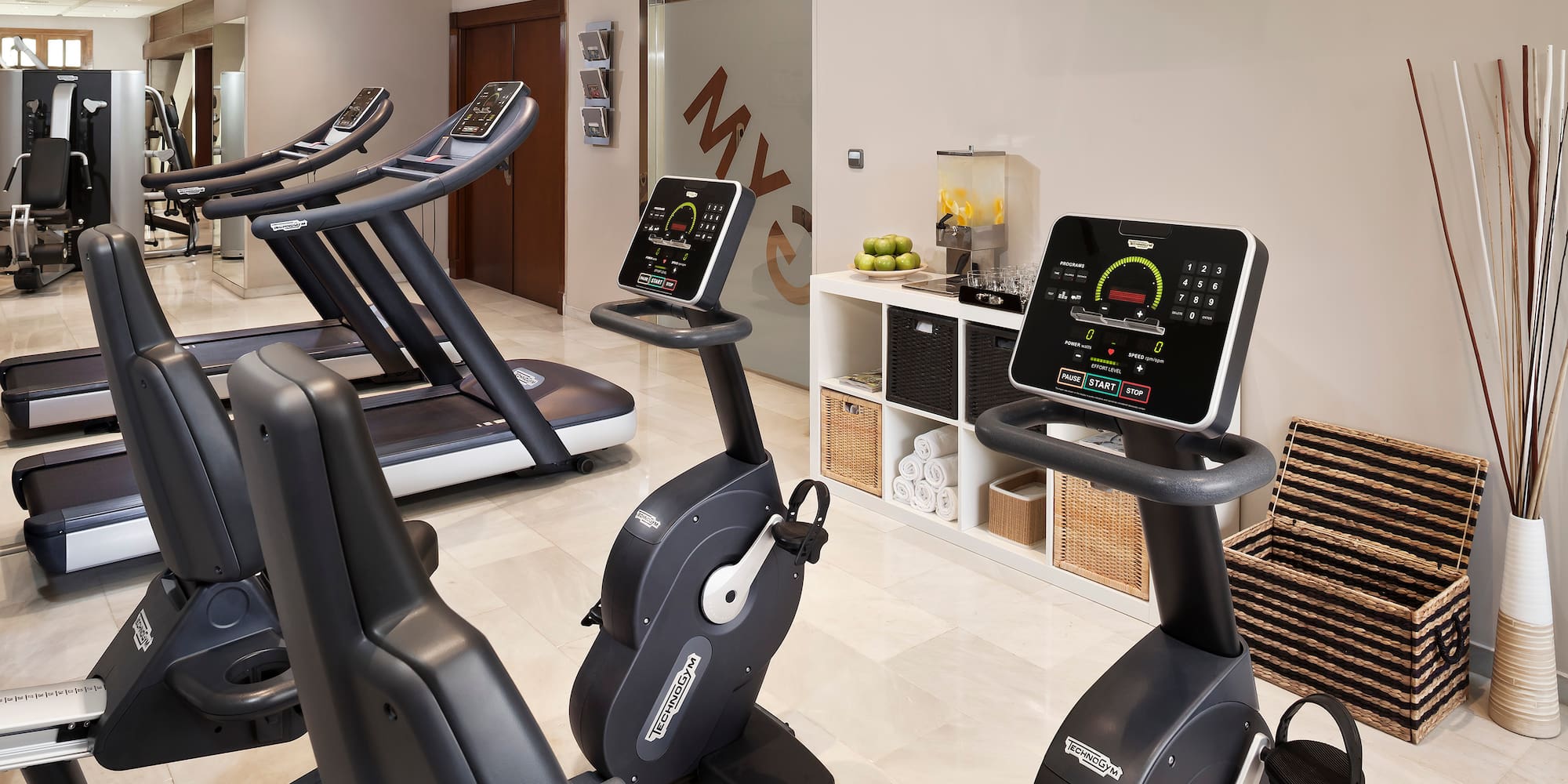 a room with exercise bikes and treadmills