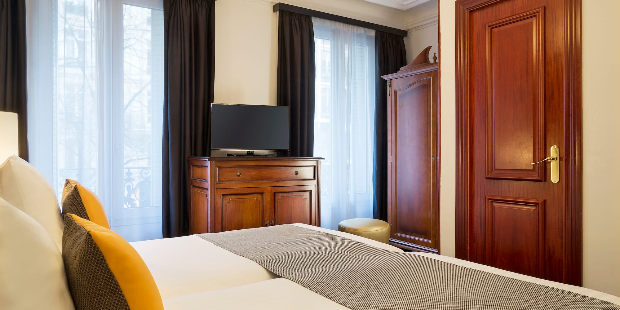 a room with a bed and a dresser