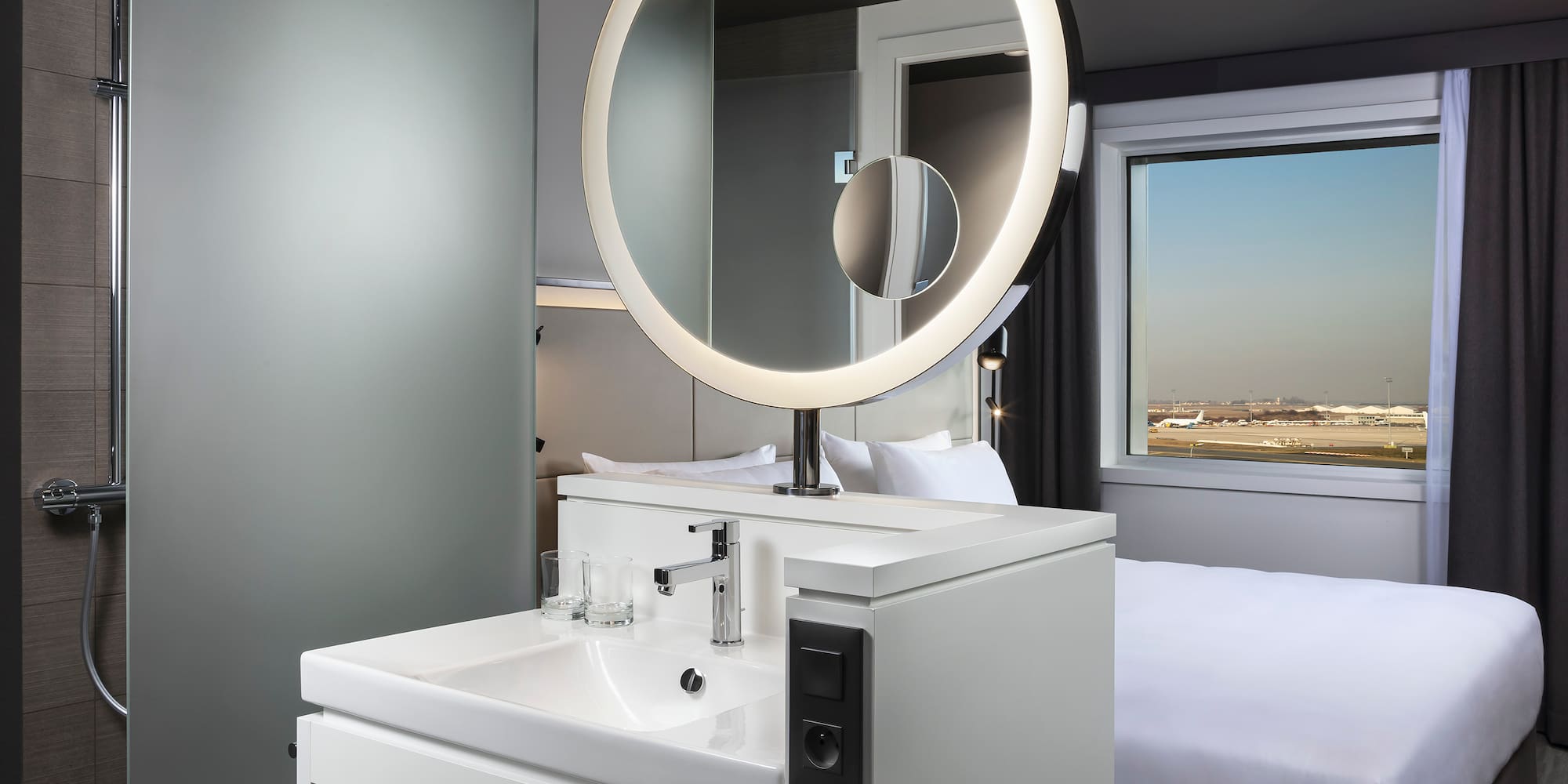 a bathroom with a round mirror