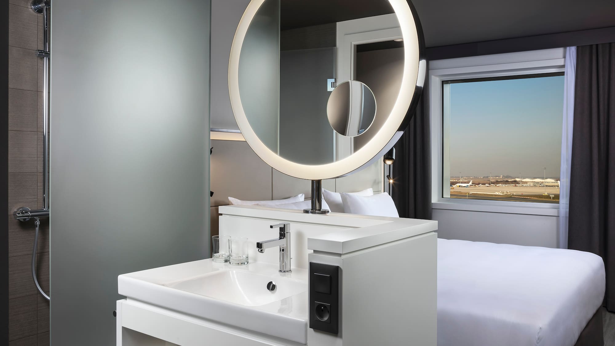 a bathroom with a round mirror