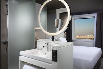 a bathroom with a round mirror