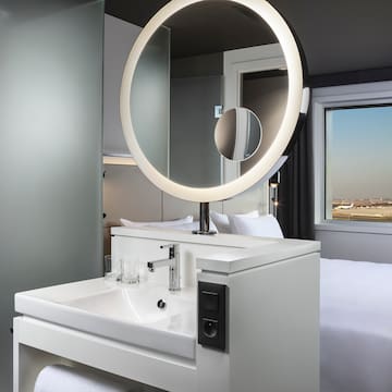 a bathroom with a round mirror