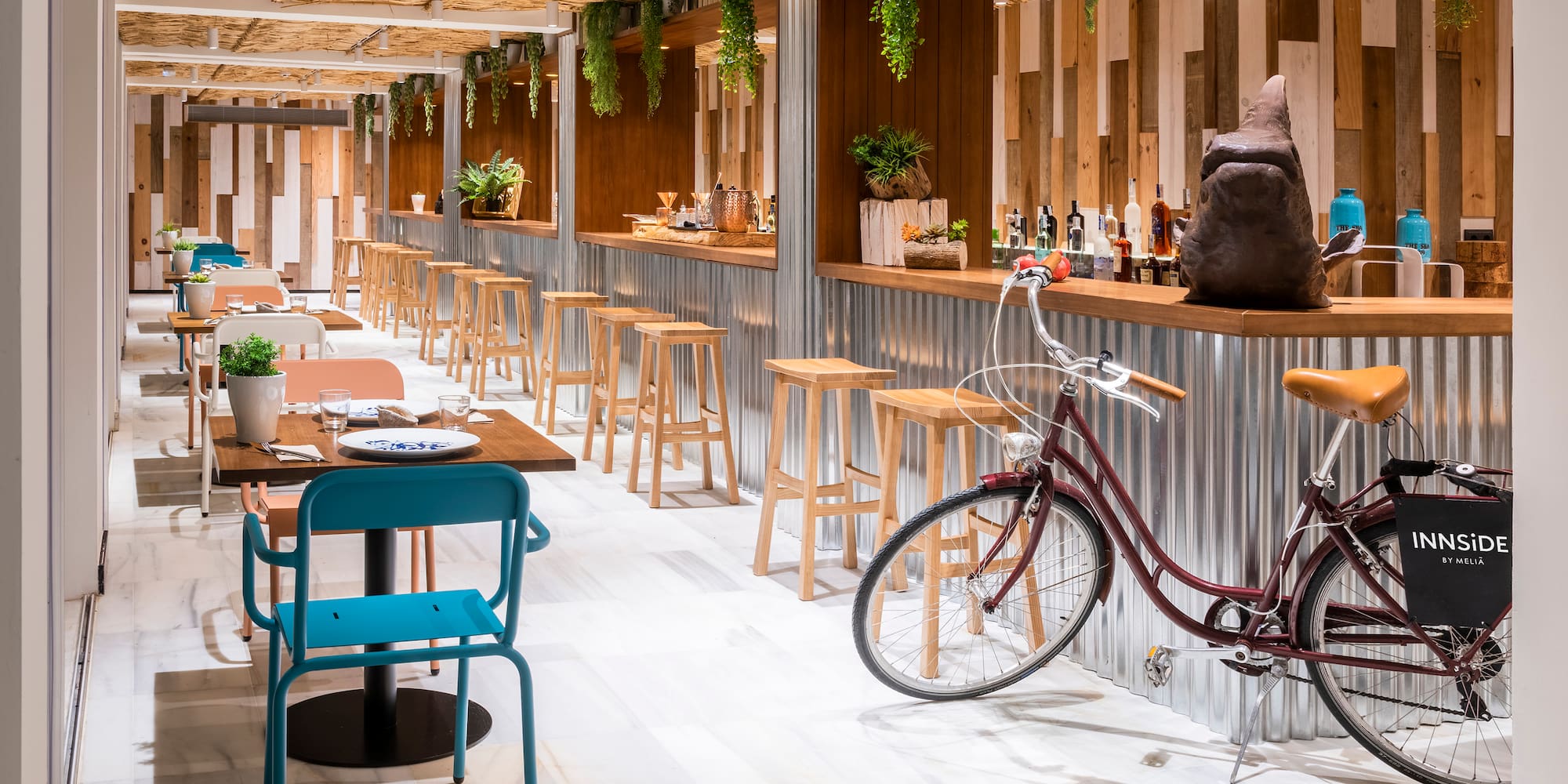 a room with tables and chairs and a bicycle