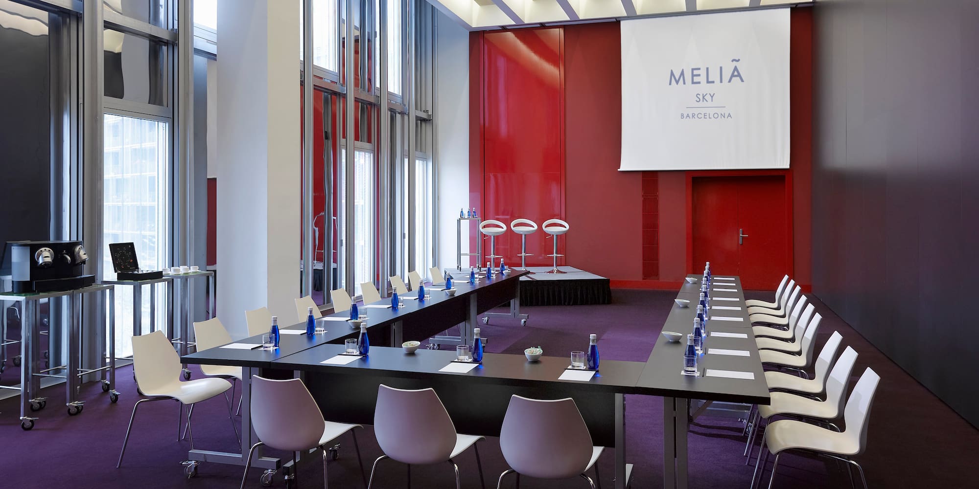 a conference room with tables and chairs