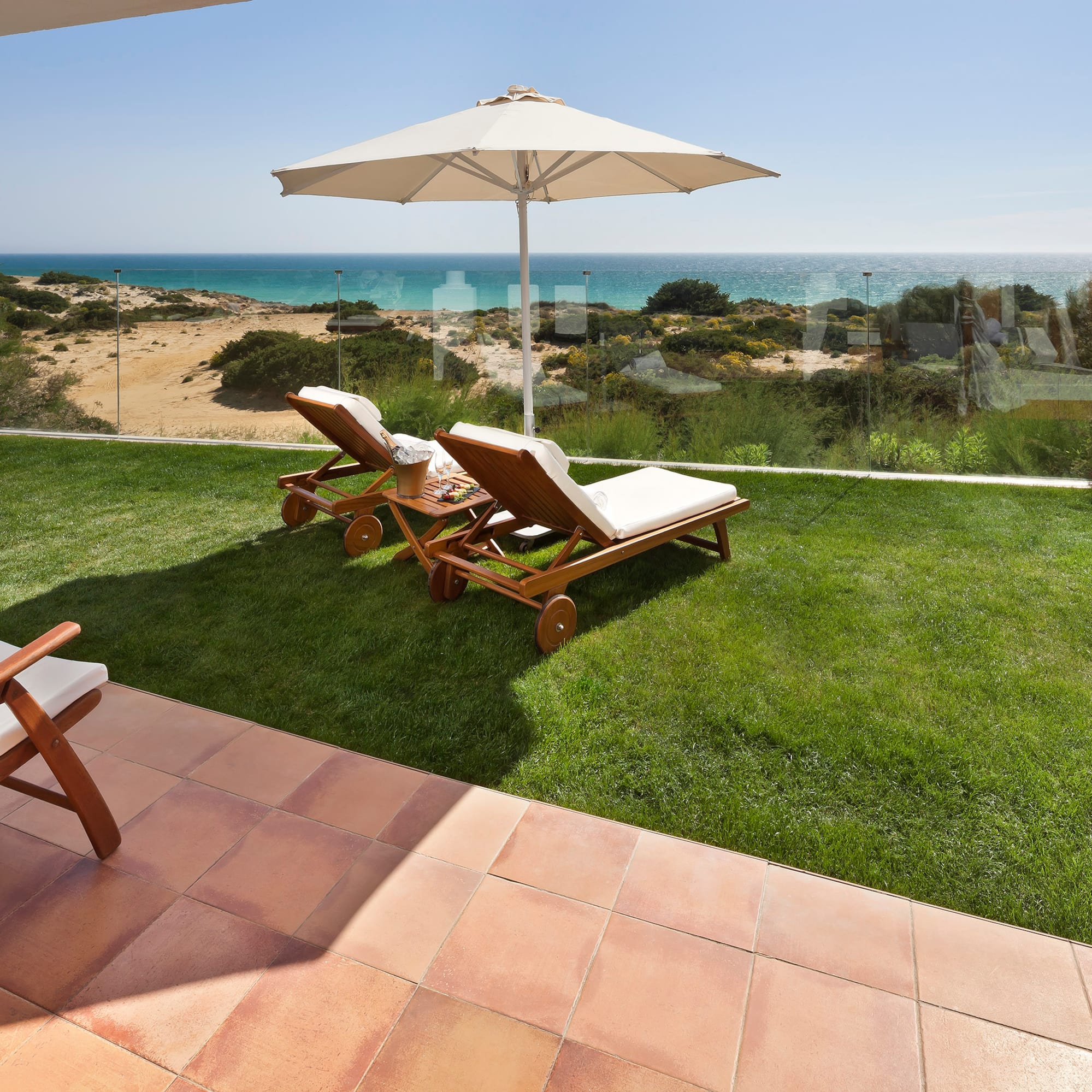 chairs and umbrella on a lawn