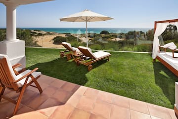 chairs and umbrella on a lawn