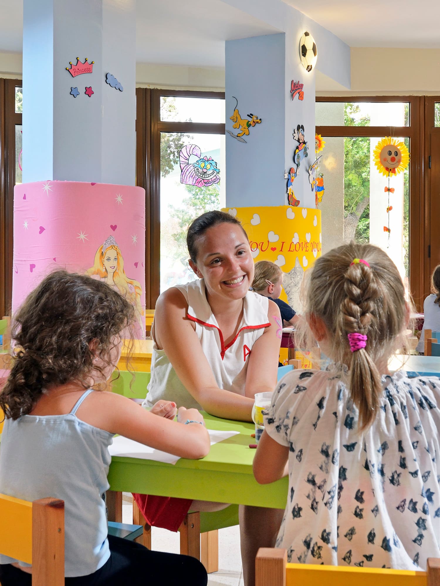 a woman and children sitting at tables