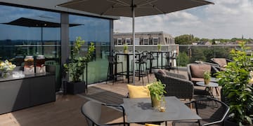 a patio with chairs and umbrella on a deck