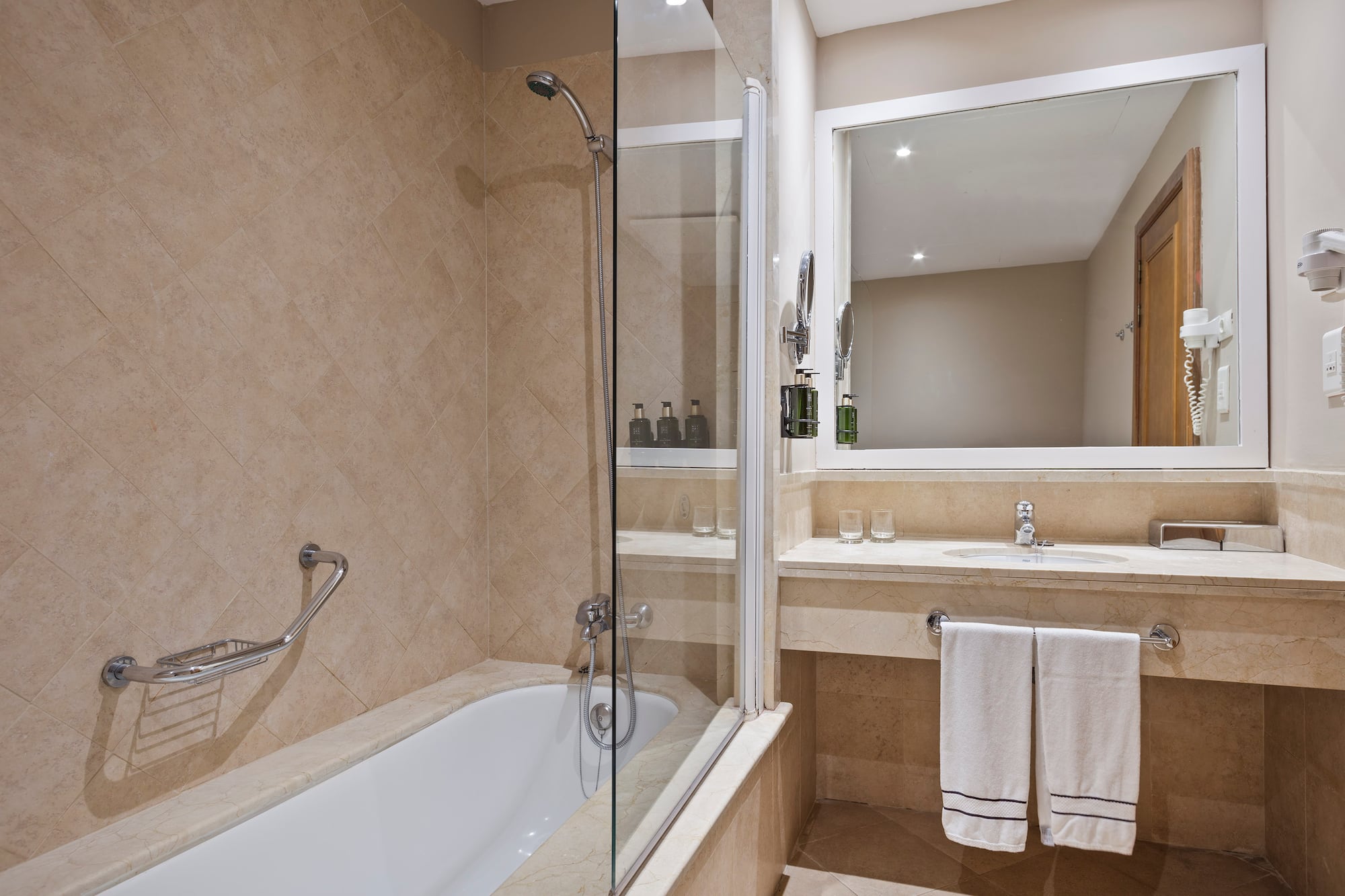 a bathroom with a glass shower door and a bathtub