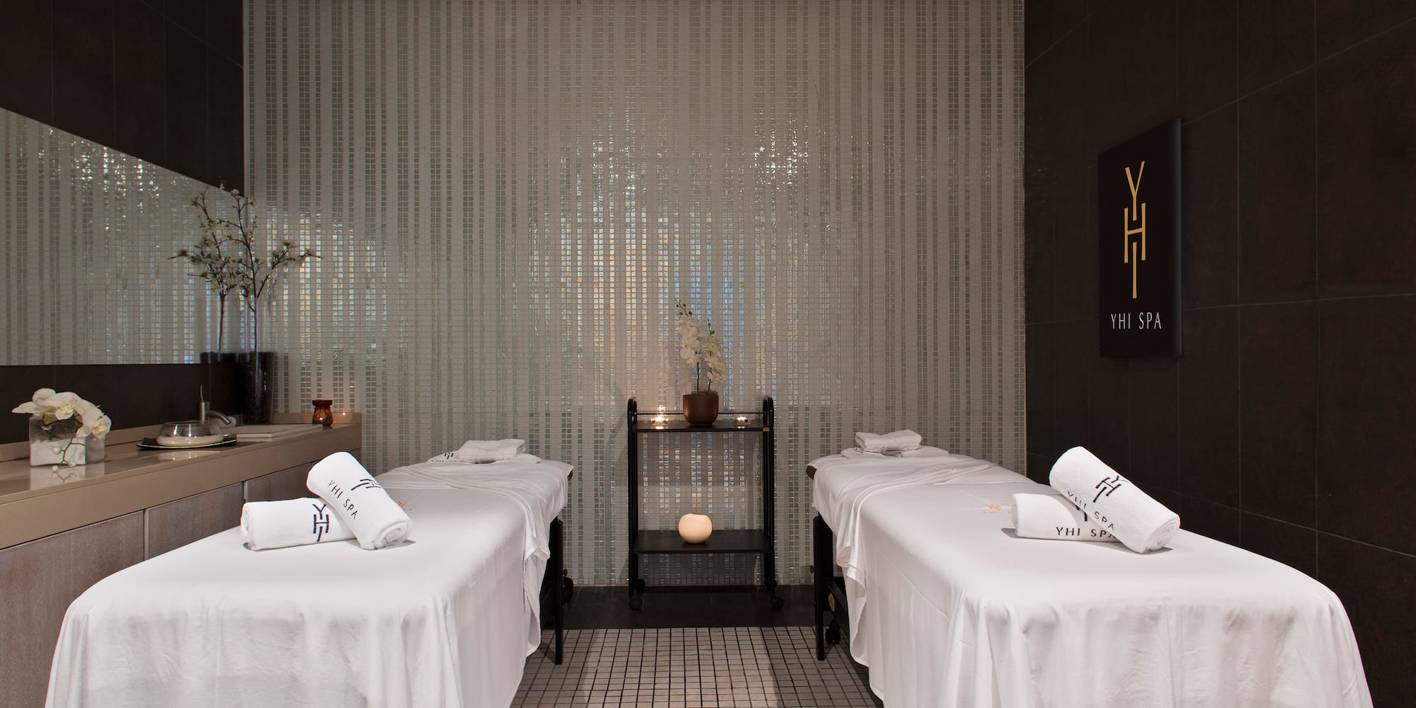 a massage room with white beds