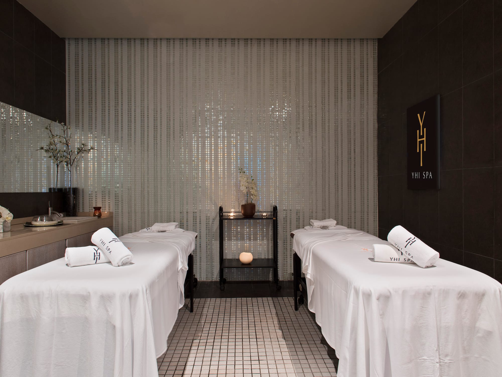 a massage room with white beds