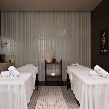 a massage room with white beds