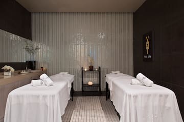 a massage room with white beds