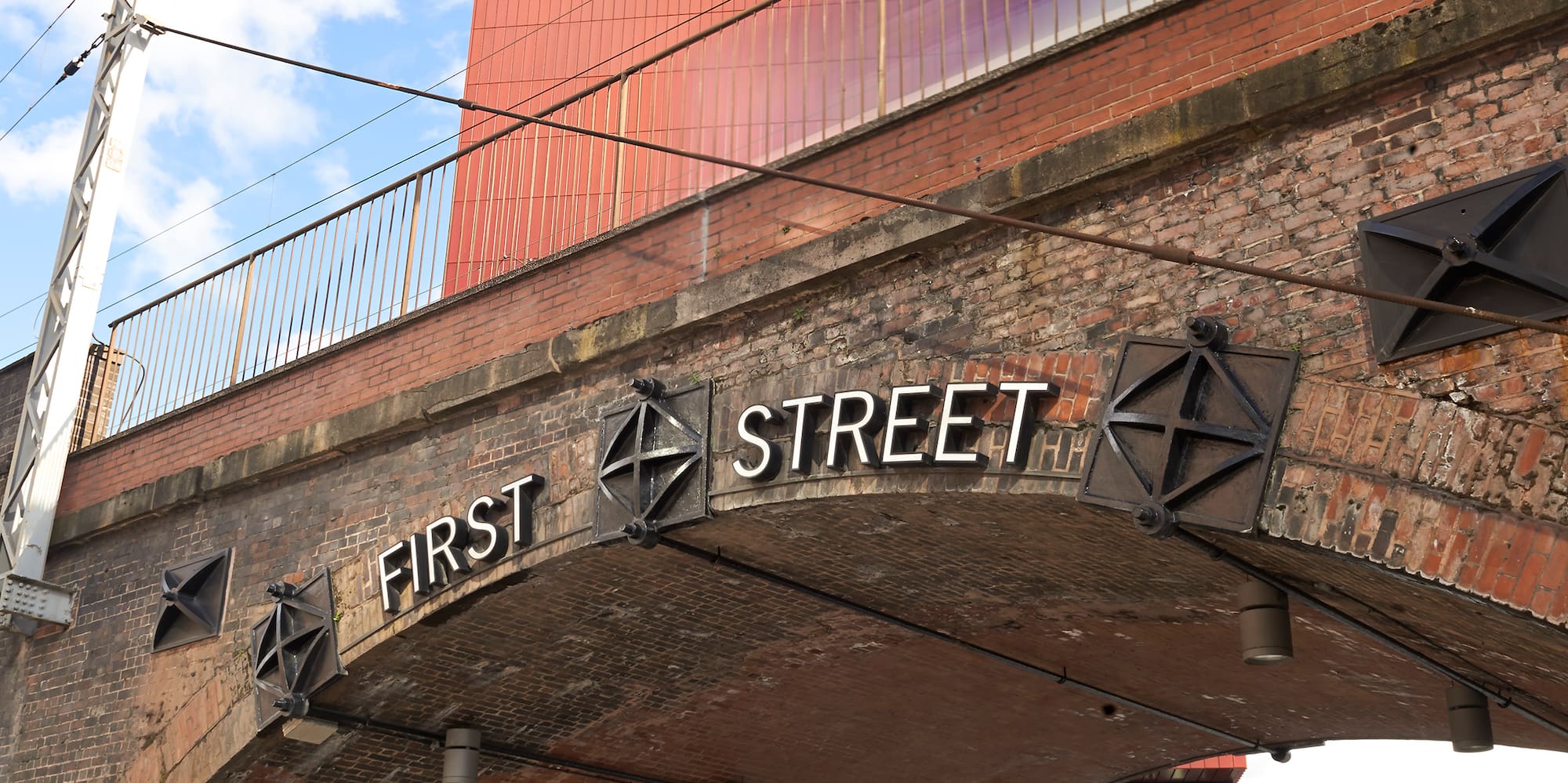 Red Innside Hotel above historic First Street brick archway, Manchester.