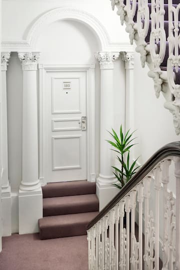 a white door with a carpeted staircase