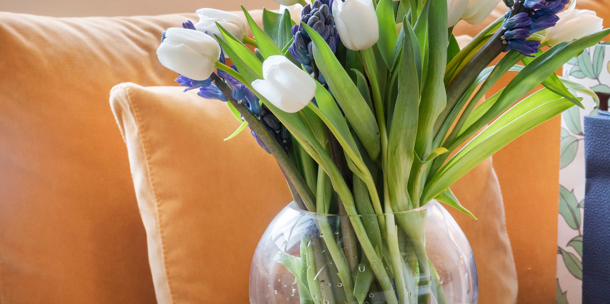 a vase of flowers and desserts on a table