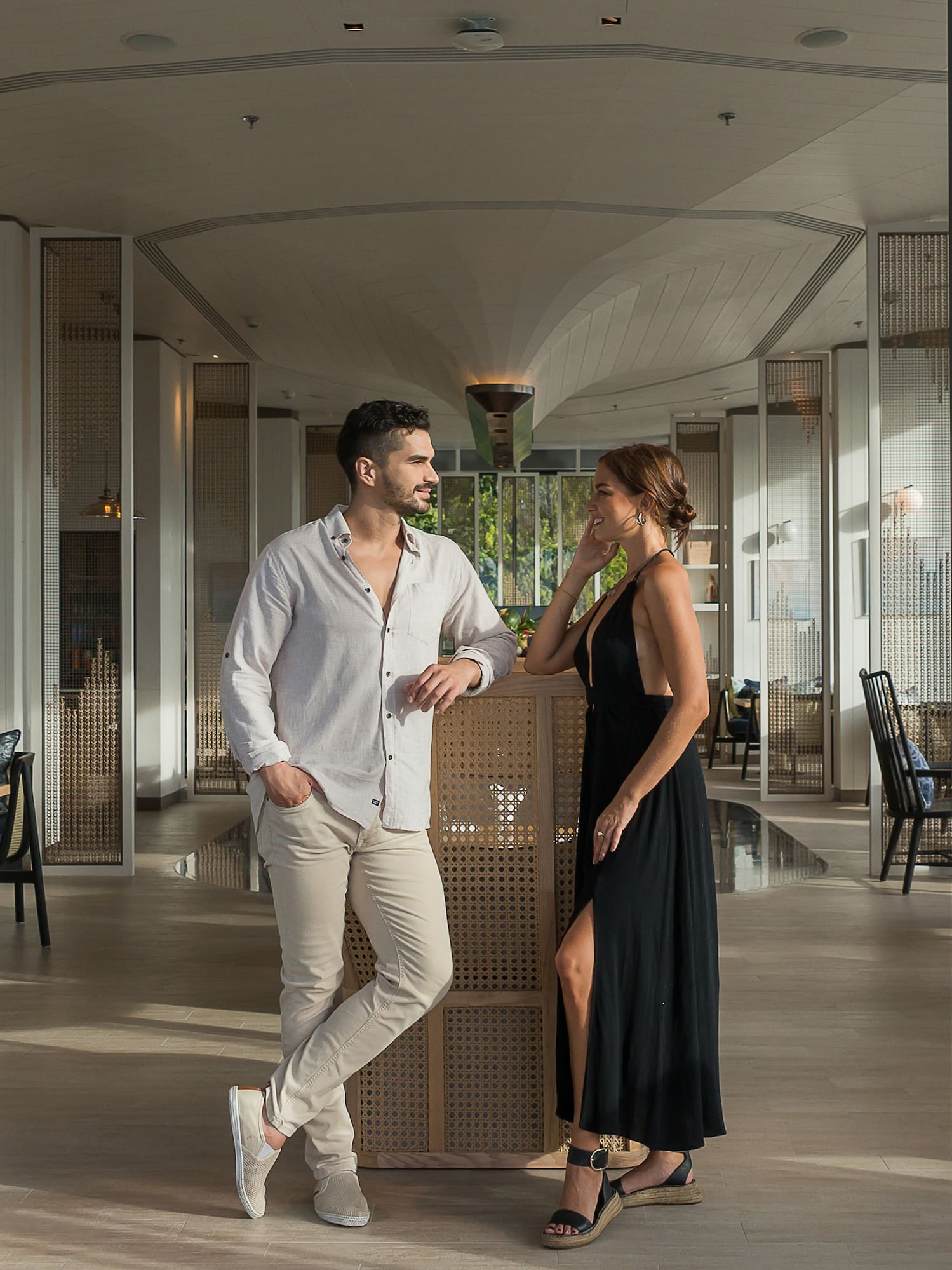 a man and woman standing in a hallway